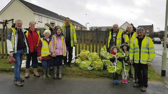 Braving the rain to clean up their village