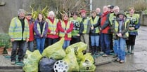 Dodging hailstorms to clean up village