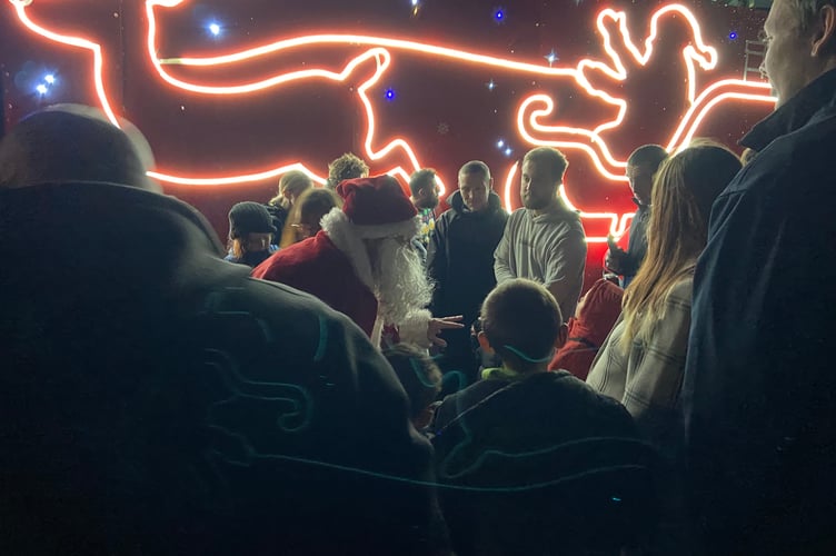 Santa greets the young children who patiently waited for him to arrive on the GoCornwall bus