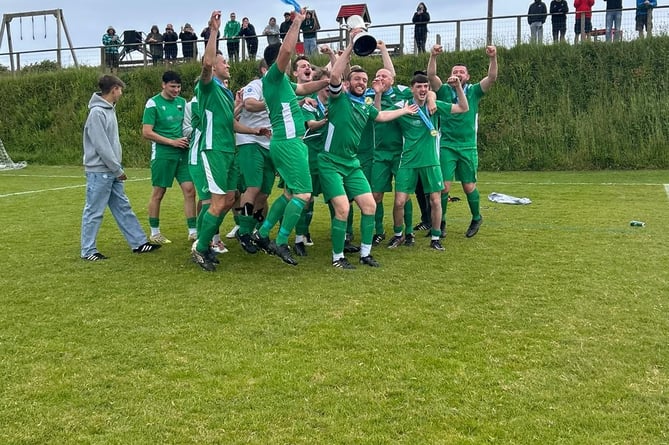 Morwenstow skipper Will Bryant and the rest of the players celebrate with the title. Picture: Morwenstow AFC