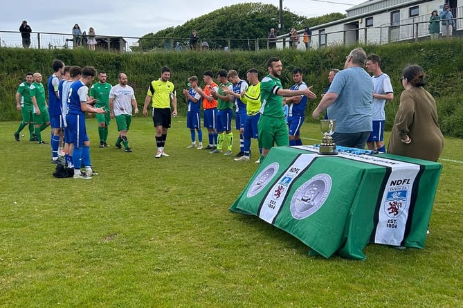 High Bickington form a guard of honour as Morwenstow go up to collect their medals.