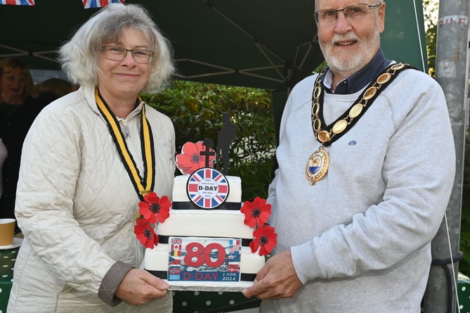 Deputy Town Mayor Claire Hewlett along with the Camelford Town Mayor Rob Rotchell with the D Day celebration cake made by Kirsty Ferguson. (Picture: Adrian Jasper)