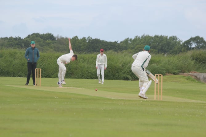 Werrington's Dan Inman, who took three wickets before making 17 with the bat, bowls to Holsworthy Seconds captain Lyndon Piper during Saturday's Division Five East clash at Ladycross.