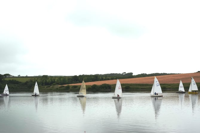 Jane Anderson leads the fleet spread out across a glassy Tamar Lake on Sunday, June 23.
