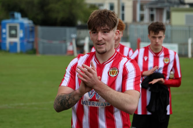 Tylor Love-Holmes applauds the supporters at a Saltash United match last season.