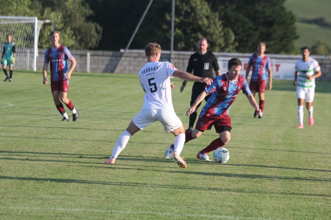 Launceston's Andy Watkins looks to take on a Mousehole defender at Pennygillam.