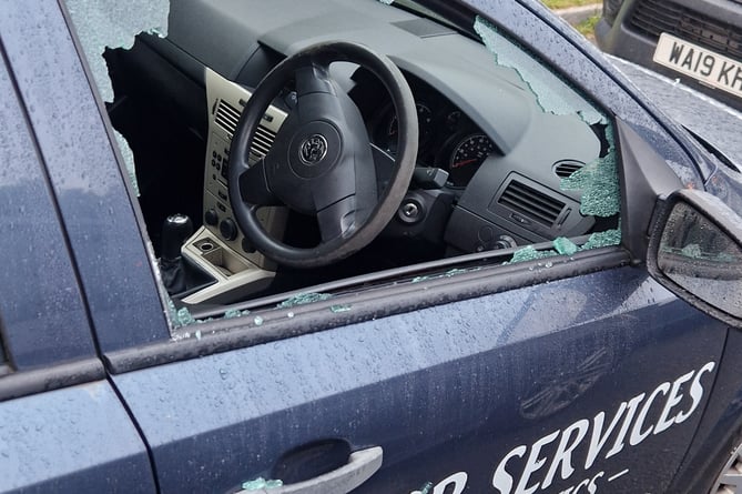 The smashed window of the courtesy car