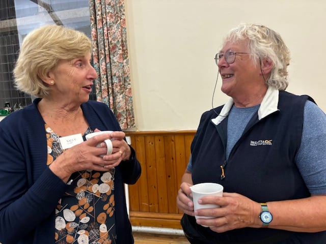 Members of Bude Women's Institute, Sally Cloke and Rosemary Lee have a chat over a cup of tea