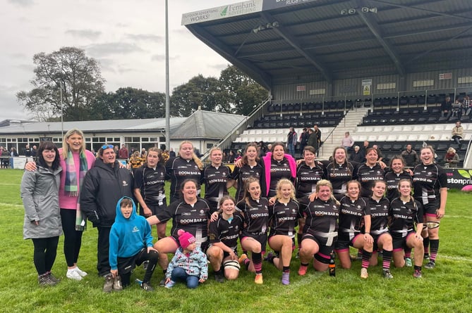 Launceston's players and supporters celebrate on the pitch at Polson Bridge after their nailbiting success over Crediton. Picture: Dan Pearce