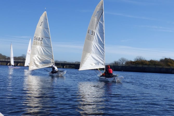 A view from on the water as Natasha Routley, crewing in Brian Pollard's Tasar, snaps the Solo battle ahead; Dave Perrett chasing Adam Hilton. 