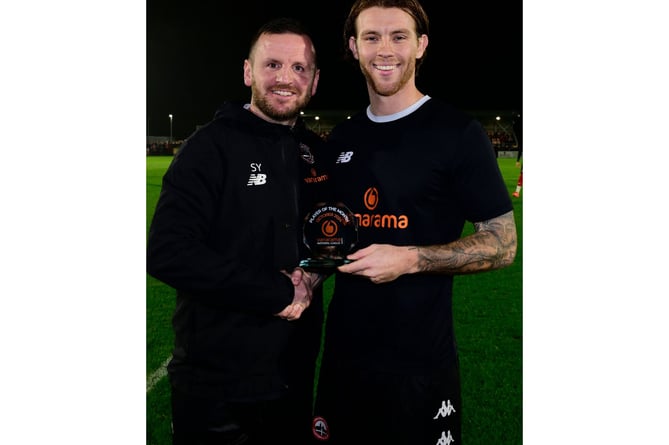 Harvey was congratulated by Truro City assistant manager Stewart Yetton. Picture: Phil Mingo PPA/UK