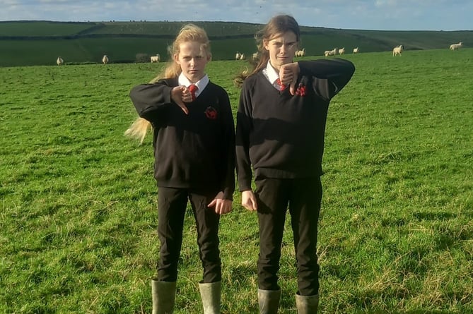 Kimberly, 12, and Pippa, 13, were sent home from Sir James Smith's School in Camelford for wearing welly boots as part of a farming protest. Their mum says they were dropped to the wrong farm and left there unsupervised (Picture: Alice Hatt)