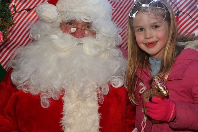 Imogen receives a gift from Father Christmas (Picture: Adrian Jasper)