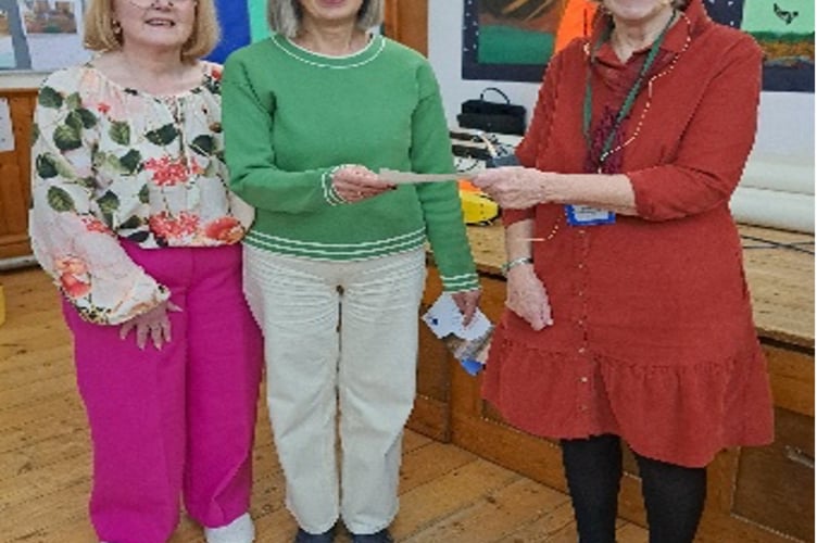 Naomi Evans and Emmy Lou Green receiving the cheque for  £1,525 which was presented by Heather Stephenson, Bude Women's Institute club secretary